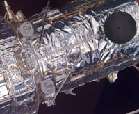 Pieces of Multi Layer Insulation protects the telescope. They look like ordinary household aluminum foil.